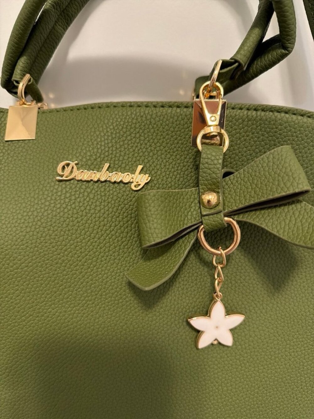 Danbaoly crossbody handbag with gold accents and a bow charm. - Picture 3 of 5